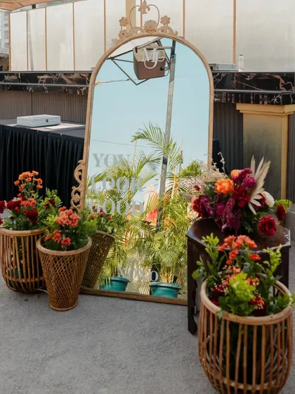 The full setup of our selfie station, complete with a vintage mirror and woven planters.