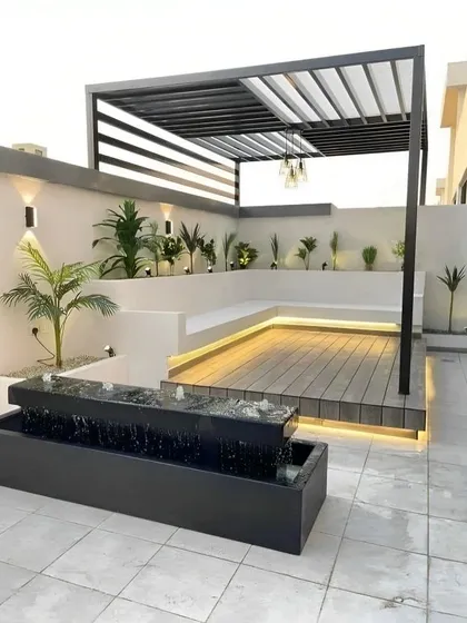 An example of our outdoor and terrace design capabilities. This space features a modern pergola, built-in seating, strategic mood lighting, and a tranquil water feature. We create these extensions of your home for relaxation and entertainment, blending natural elements with contemporary aesthetics.