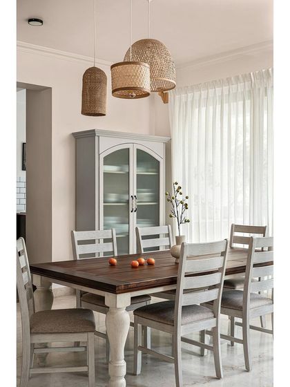 In this dining area, I kept the design simple and minimal. The standout piece is a custom vintage-style crockery unit. Above the table, wicker lights add a natural texture and create a warm, inviting atmosphere for meals.