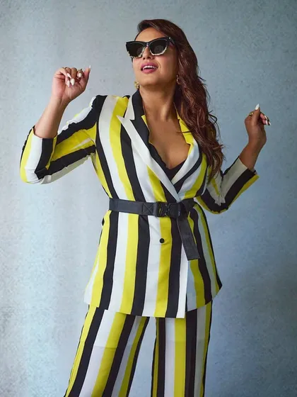 This striped pantsuit from Cilvr Studio is bold and graphic. The belted waist and strong shoulder create a powerful silhouette, perfect for a fashion-forward look.