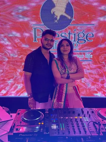 Posing with another DJ at the Prestige Group's Dandiya event. The lighting and stage setup were incredible.