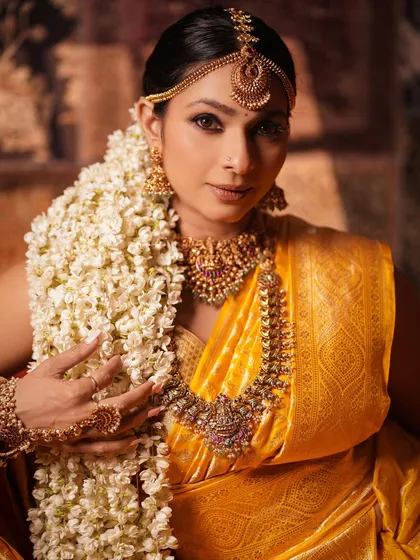 A close-up of Tanishaa Mukerji, focusing on the magnificent temple jewelry. This shot details the craftsmanship of the necklace, earrings, and matha patti, central to the divine look.