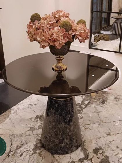 Another view of the elegant accent table with its black marble base, showcasing its ability to anchor a corner and provide a beautiful surface for decor.