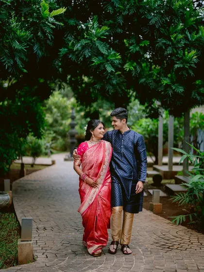 A stroll through a lush green pathway becomes a romantic moment for Apeksha and Rutwij during their engagement session in Pune.