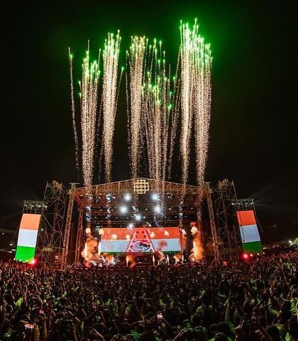A patriotic moment with the stage lit up in the colors of the Indian flag during Armin's performance.