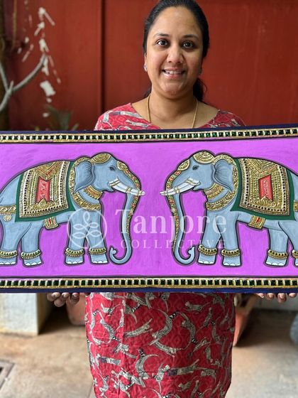 A student's beautiful painting of two elephants with a contemporary pinkish-purple background, showing how traditional art can be personalized.