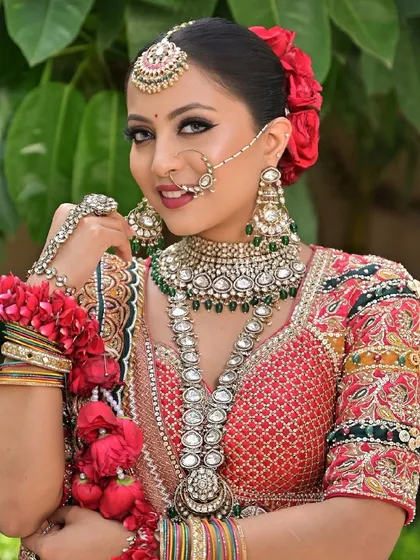 A happy bride, glowing and ready for her big day. Her natural beauty is enhanced with a look that is both traditional and fresh, featuring defined eyes and a bright smile.