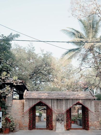 The grand entrance to The Tamarind Tree, with its rustic brickwork and traditional tiled roof, offering a warm welcome.