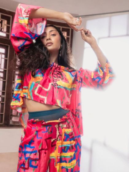 This look features a different way to style the Advait co-ord set, with a cropped, bell-sleeve top. The model's pose is graceful and dynamic, highlighting the movement and playful silhouette of the outfit.