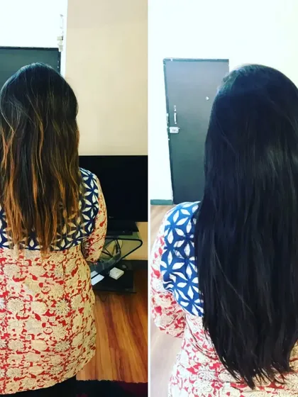 This client's hair was transformed from colored and mid-length to a uniform, dark, and long style. The extensions provide a consistent, healthy look from root to tip.