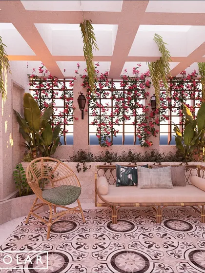 Another view of the terrace, showing a cozy seating nook with a rattan sofa. The design is inspired by Mediterranean courtyards, creating a dreamy and inviting outdoor living space.