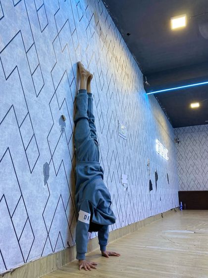 Wall-assisted handstands are a safe way to build the strength and confidence needed for freestanding handstands. This is a common drill in our conditioning sessions.