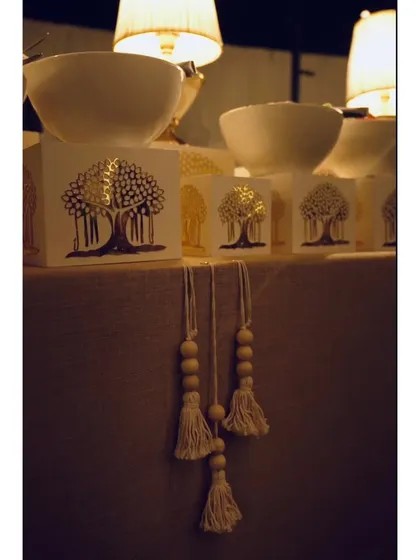 Details from a themed buffet station, featuring custom-designed risers with a tree motif and decorative tassels, adding a unique, handcrafted touch.