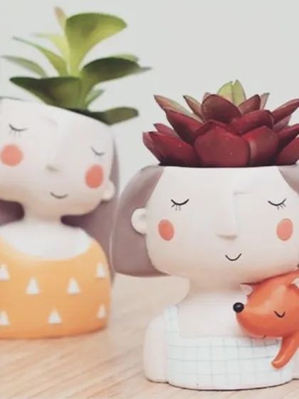 For a gift that's full of personality, I offer these quirky and adorable mini planters. They are perfect for housing small succulents and make for a delightful desk companion or a thoughtful personal gift that is sure to bring a smile. This one holding a little fox is a particular favorite.