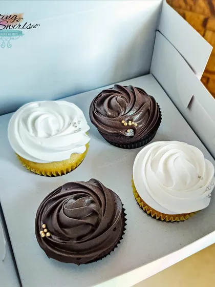 Sometimes, simple is best. This classic box of four cupcakes, with two vanilla and two chocolate, features elegant swirls of frosting and a touch of edible glitter, making for a perfect little gift.