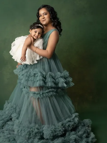 Where grace meets giggles. A mother holds her daughter, both looking absolutely radiant. These mother-daughter portraits are always among my favorites.