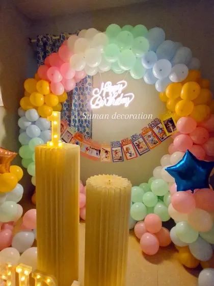 A close-up of the pastel rainbow balloon arch, showing the soft blend of colors perfect for a first birthday party.