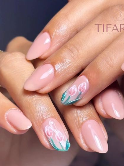 A full view of the beautiful and subtle tulip nail art on natural nails.