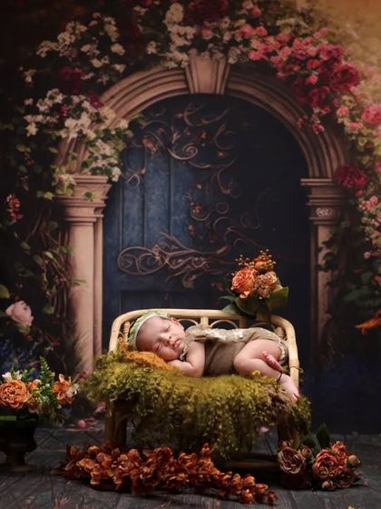 A secret garden theme. This enchanting setup features a baby on a mossy bed in front of a magical floral archway, creating a fairytale-like portrait.