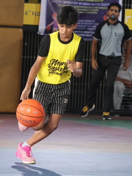 A young player drives past a defender during a match. We encourage our players to be aggressive and confident with the ball in their hands.