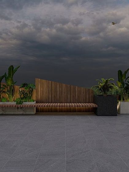 An upcoming project in Greater Kailash, Delhi, featuring minimalist design. This section showcases custom planters with built-in wooden bench seating, surrounded by lush greenery for a clean, modern look.