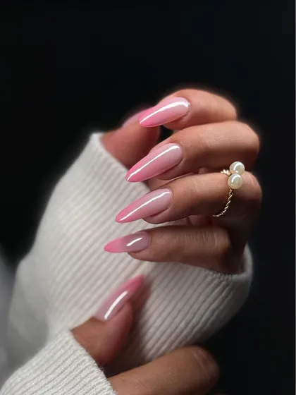 Soft, seamless, and sophisticated. This beautiful pink and white ombre nail set, finished with a high-gloss top coat, offers a timeless and feminine look on elegant almond-shaped extensions.