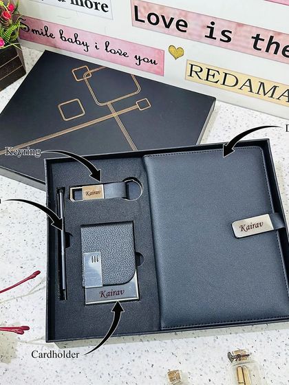 This 4-in-1 combo is a complete office essentials kit. It includes a personalized lock diary, a card holder, a metal pen, and a metal hook keychain, all in black and presented in a sophisticated gift box.
