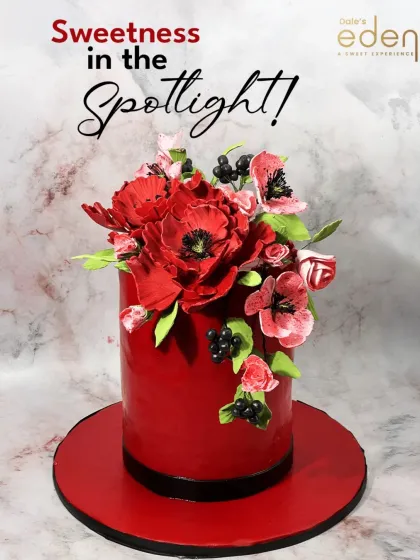 Sweetness in the spotlight. This tall, vibrant red cake is topped with a stunning arrangement of handcrafted red sugar poppies, making it a bold and artistic statement.