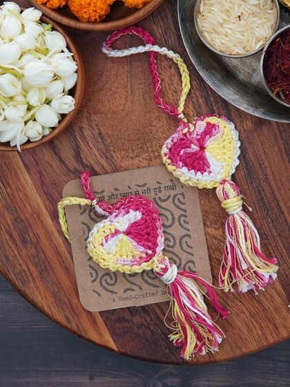 Two pink and yellow Lumbas, ready to be gifted. They make this Rakhi extra special and memorable.