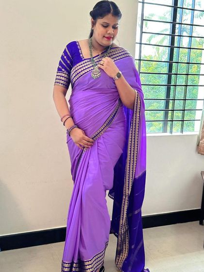 Our client looks absolutely elegant in this trending lavender pure Mysore crepe silk saree. The contrast royal blue blouse with zari work complements the saree perfectly.