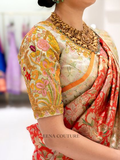 My client Harshitha radiates pure elegance in this stunning ensemble. I paired a vibrant, floral Banarasi silk saree with a custom blouse featuring multi-colored thread embroidery that perfectly picks up the hues in the saree.