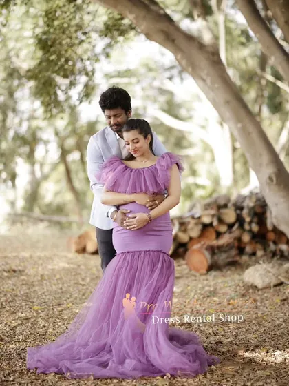 A tender couple's portrait featuring the lavender mermaid gown. This style is perfect for capturing intimate moments while still showcasing a glamorous and fashionable maternity look.