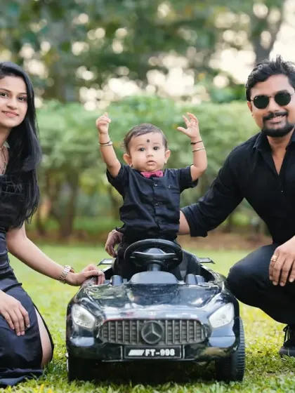 A stylish family portrait taken outdoors with their son and his favorite toy car. I love coordinating outfits and props to create a cohesive and polished family photo.