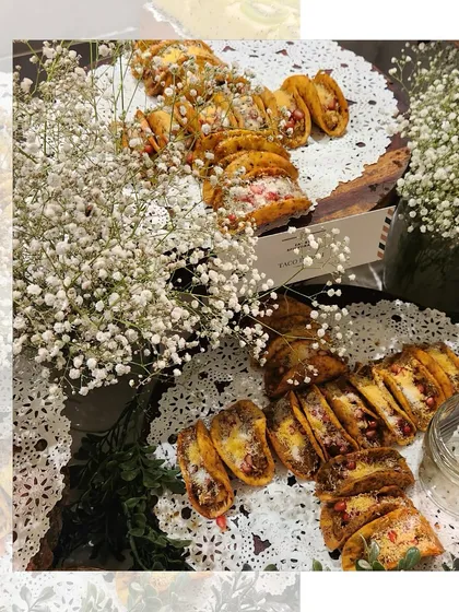 Our fusion tacos, filled with deliciousness and garnished with fresh baby's breath. The delicate presentation on doilies makes them a beautiful addition to any grazing table.