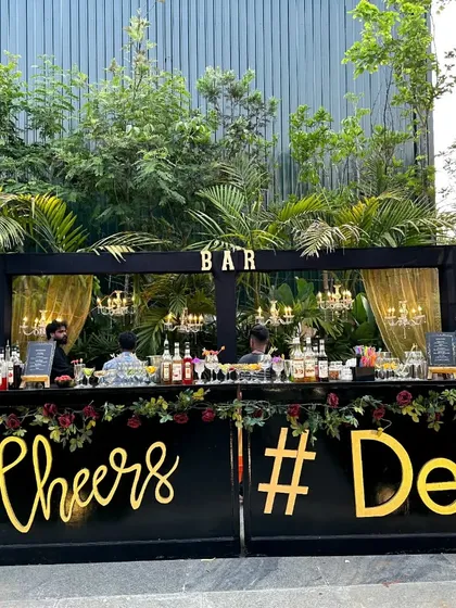 This is our classic black and gold wedding bar setup, perfect for an elegant cocktail party. We customize the bar front with details like the event hashtag, making it a central feature of your celebration.