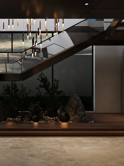 This angle captures the view through the glass wall next to the staircase, connecting the moody interior with the sky outside and creating a beautiful play of light and reflection.