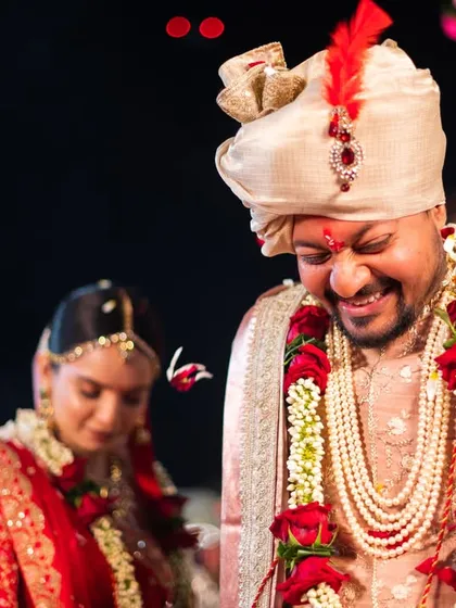 A candid shot of the groom's happy expression during the wedding rituals.