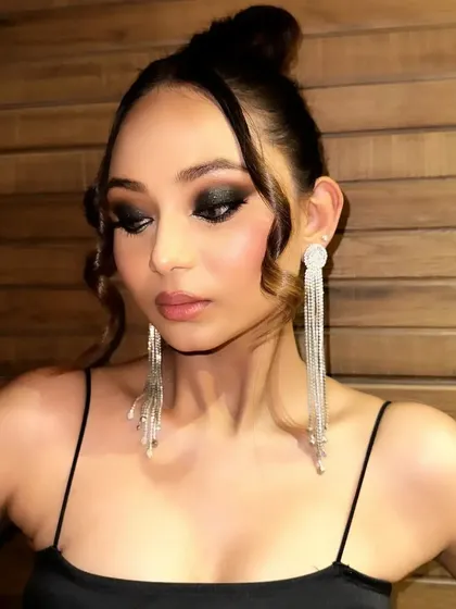 A classic black smokey eye with a touch of glitter, perfect for a glamorous evening event or a bold editorial shoot. The look is intense, dramatic, and timeless.