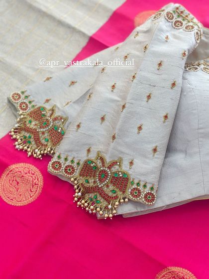 A close-up of the peacock motifs, crafted with red and green stones.