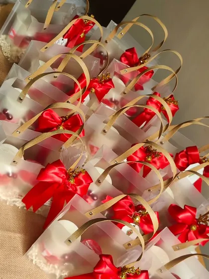 Another view of the New Year gift bags, showing how the red ribbons and gold handles create a beautiful and festive presentation for bulk gifting.