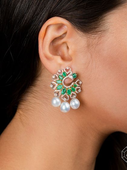 These Zambian Emerald, Diamond, and Pearl Earrings bring a touch of fantasy and grace to any event.