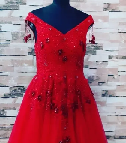 For a big celebration, I can create a custom party gown like this one in bright red. It is an off-shoulder design with detailed beadwork, perfect for making a statement at any event.