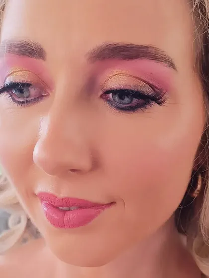 Just looking like a wow! A close-up of a vibrant and fun party look with bright pink and gold eyeshadow.