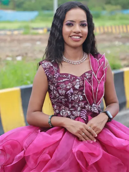 A bright and happy look in a magenta gown. The student's makeup work enhances the model's joyful expression.