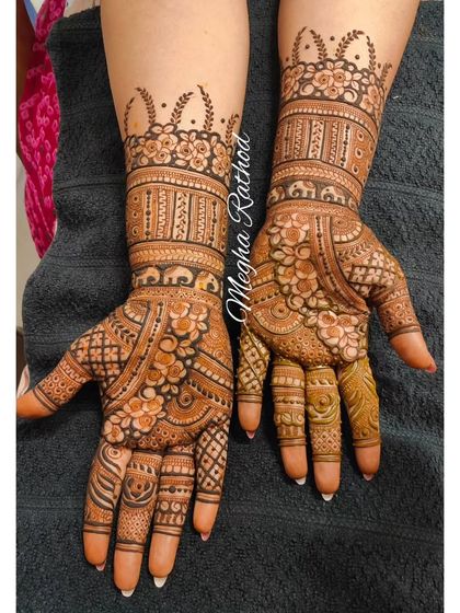 A beautiful, full-hand design with a mix of floral and geometric patterns. The crown-like border at the top adds a touch of royal elegance.