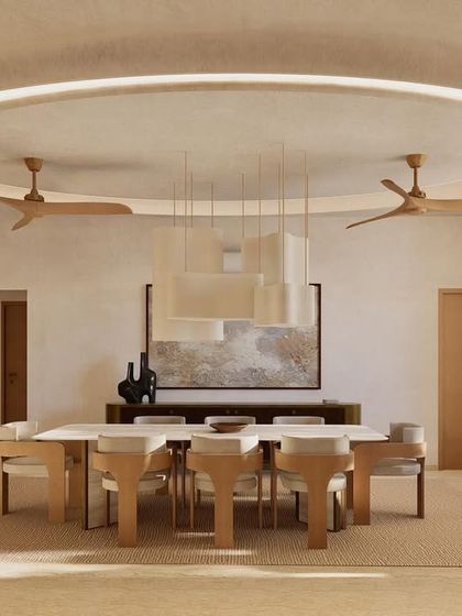The dining area at Kumo House is a study in refined simplicity. A large table is surrounded by sculptural chairs, all under a statement pendant light, creating a perfect setting for shared meals.