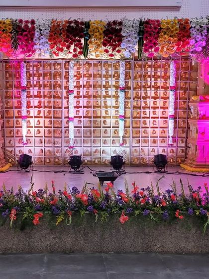 The same grand stage, transformed with pink uplighting to create a different mood for the evening's celebrations.