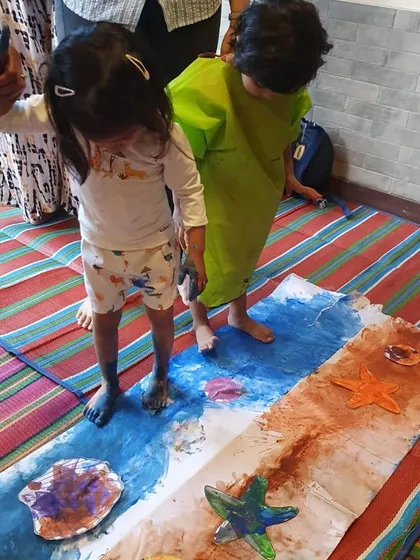 Who needs a paintbrush when you have feet? This activity is all about sensory exploration, as these two children walk along a paper river, creating beautiful patterns with paint on their feet. It’s messy, fun, and a total hit.
