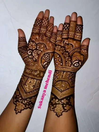 A stunning engagement mehendi with a mix of traditional motifs. The design is balanced with open spaces to make the intricate patterns stand out.