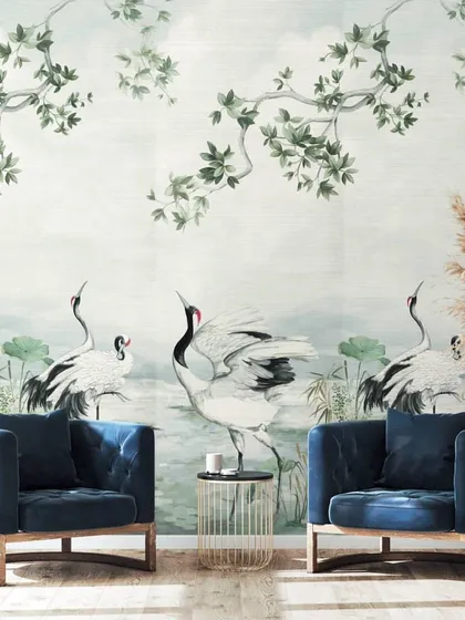This scenic wallcovering from the Daisy Bennett collection transforms a sitting area into a work of art. The hand-painted style, featuring elegant cranes amidst serene foliage, offers a bespoke, poetic quality that elevates the entire space.